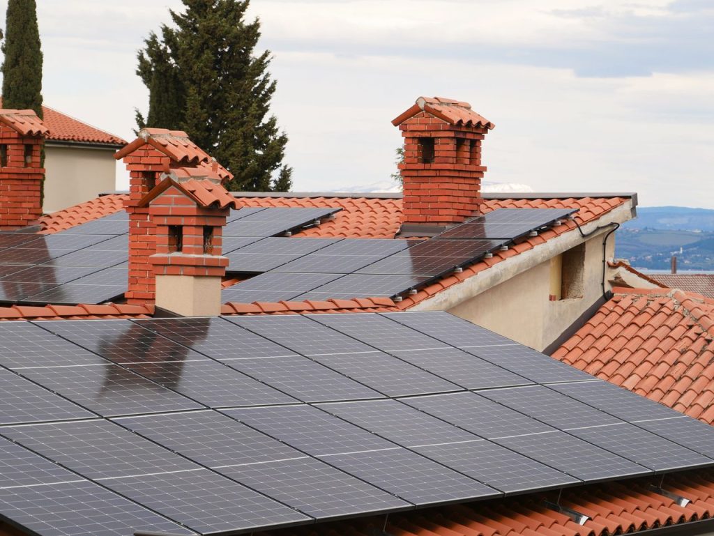 The Art of Drawing Readers In: Your attractive post title goes here Solar panels on tiled roofs of houses with chimneys, capturing clean energy.